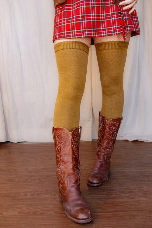 A person wearing Longer extraordinary Thigh Highs in ochre