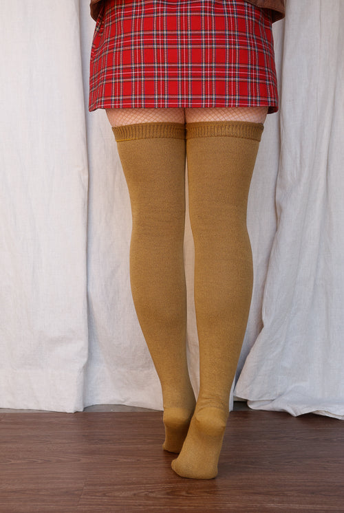 A person wearing Longer extraordinary Thigh Highs in ochre