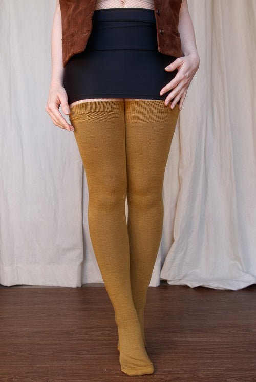 A person wearing Longer extraordinary Thigh Highs in ochre