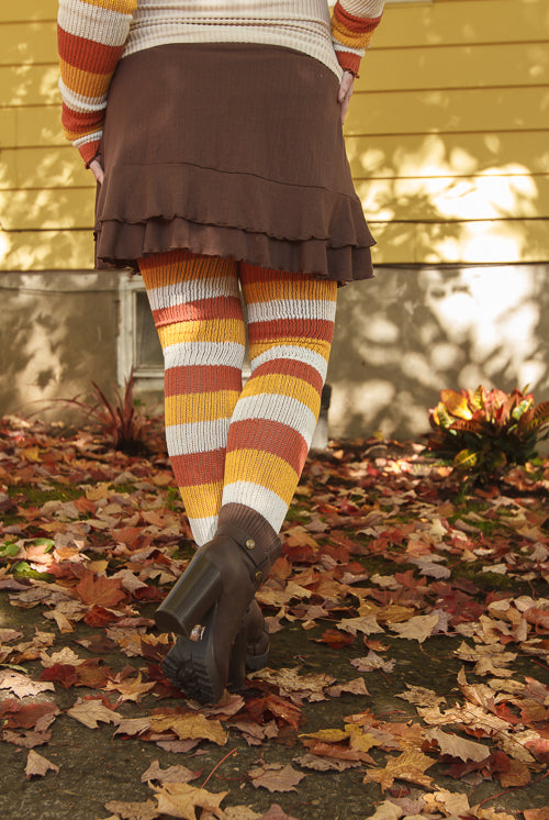 A person wearing Candy Corn striped thigh highs
