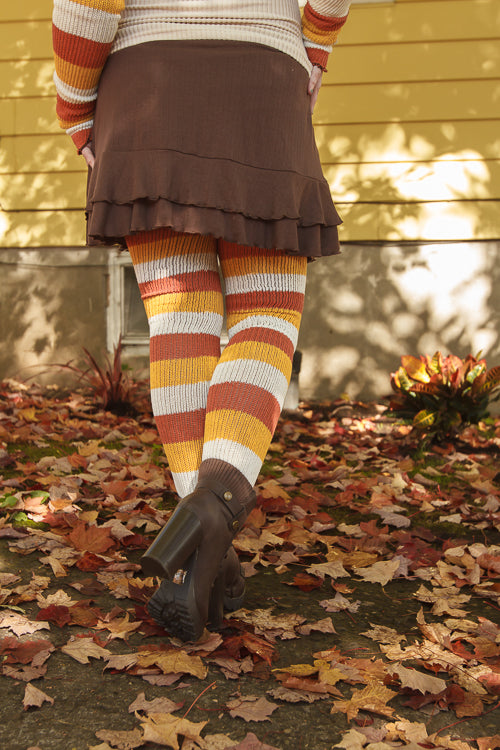A person wearing Candy Corn striped thigh highs