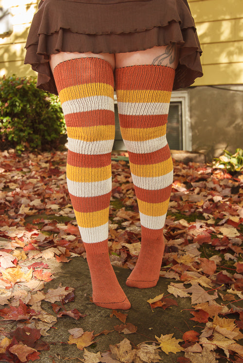 A person wearing Candy Corn striped thigh highs