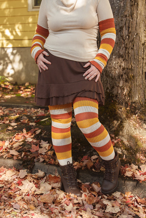 A person wearing Candy Corn striped warmers and matching thigh highs