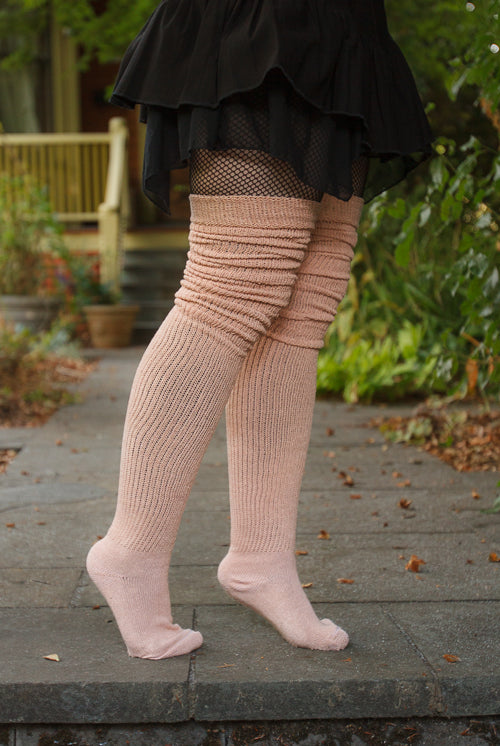 A person wearing long cuffable scrunchable socks in toe beans pink