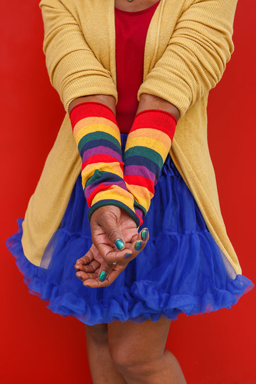 A person wearing M Sleeves in rainbow