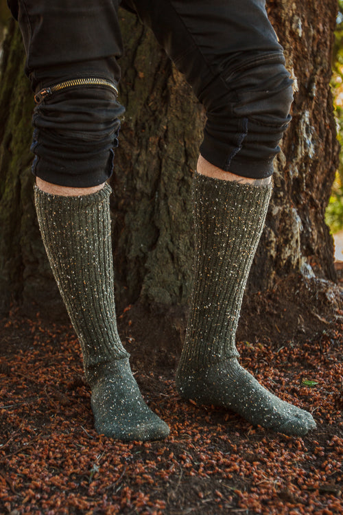 A person wearing OG Bootsocks in green