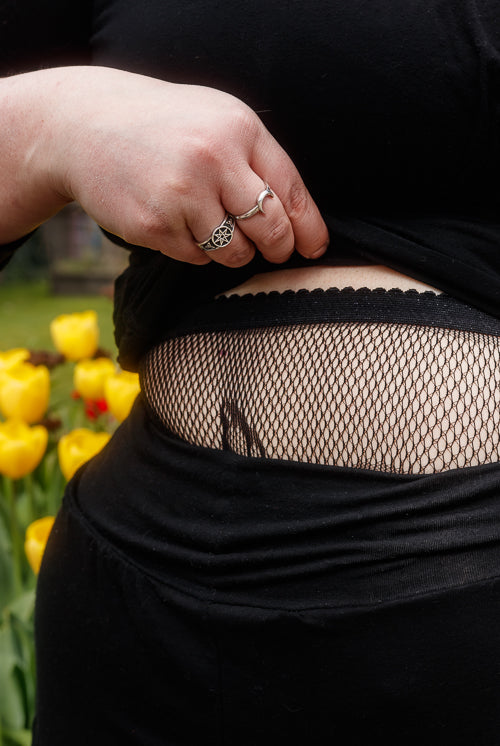 A person wearing Plus size butterfly net tights in black
