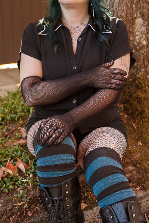 A Person wearing opera-length fishnet gloves