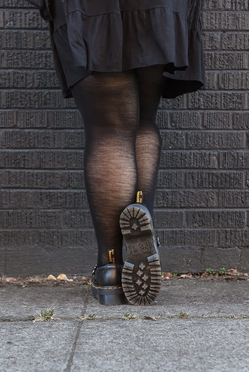 A person wearing Jennifer Wool Tights in black