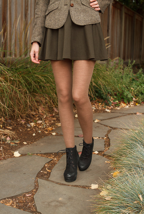 A person wearing Jennifer Wool Tights in hazelnut