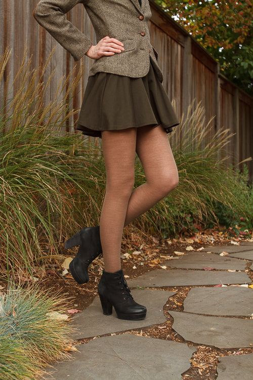 A person wearing Jennifer Wool Tights in hazelnut
