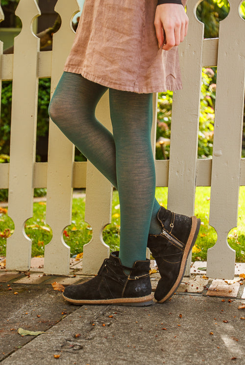 A person wearing Jennifer Wool Tights in pine