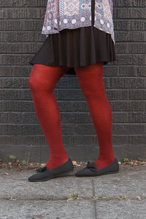 A person wearing Jennifer Wool Tights in wine