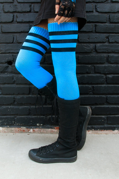 A person wearing Electric Shock thigh highs in neon blue with black stripes