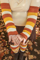 A person wearing Candy Corn striped warmers
