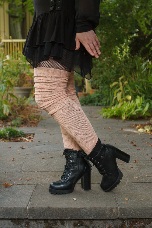 A person wearing long cuffable scrunchable socks in toe beans pink