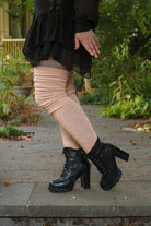 A person wearing long cuffable scrunchable socks in toe beans pink