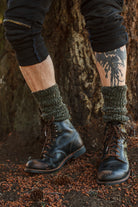 A person wearing OG Bootsocks in green