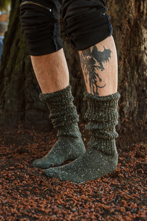 A person wearing OG Bootsocks in green