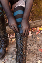 A Person wearing opera-length fishnet gloves
