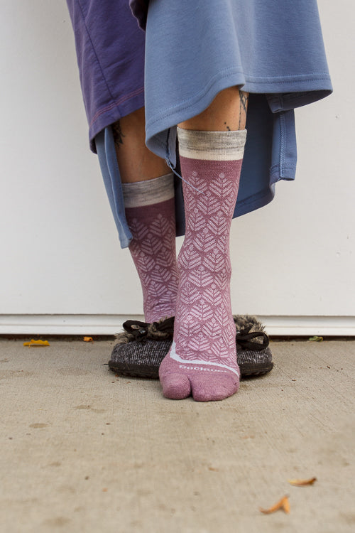 A person wearing bunion relief tabi socks in orchid