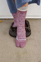 A person wearing bunion relief tabi socks in orchid