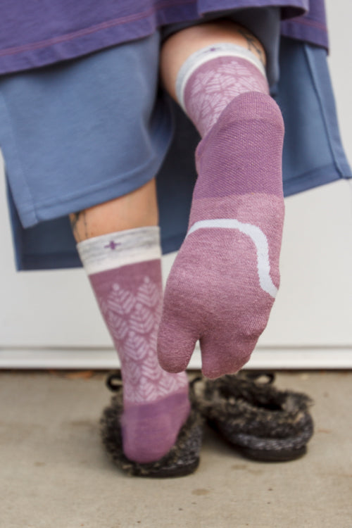 A person wearing bunion relief tabi socks in orchid