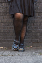 A person wearing Jennifer Wool Tights in black
