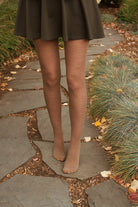A person wearing Jennifer Wool Tights in hazelnut