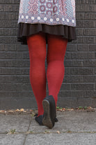 A person wearing Jennifer Wool Tights in wine