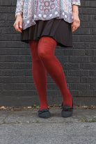 A person wearing Jennifer Wool Tights in wine