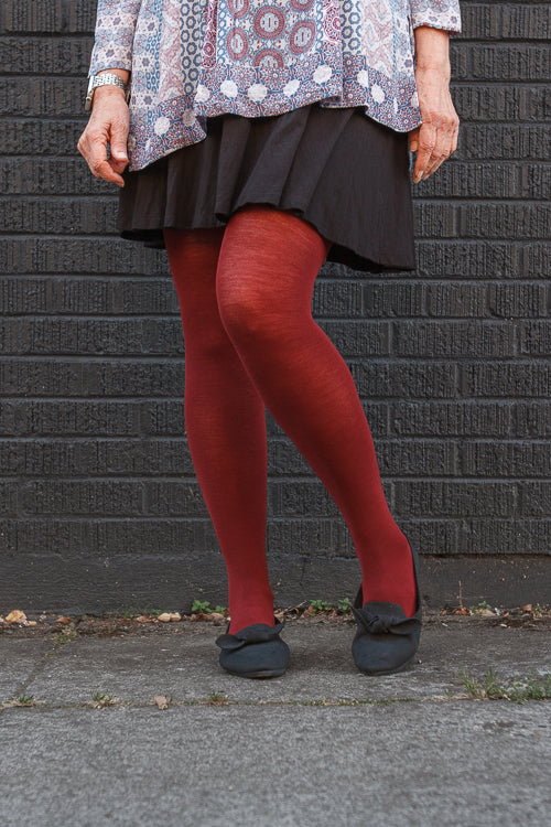 A person wearing Jennifer Wool Tights in wine