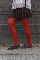 A person wearing Jennifer Wool Tights in wine