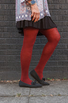 A person wearing Jennifer Wool Tights in wine