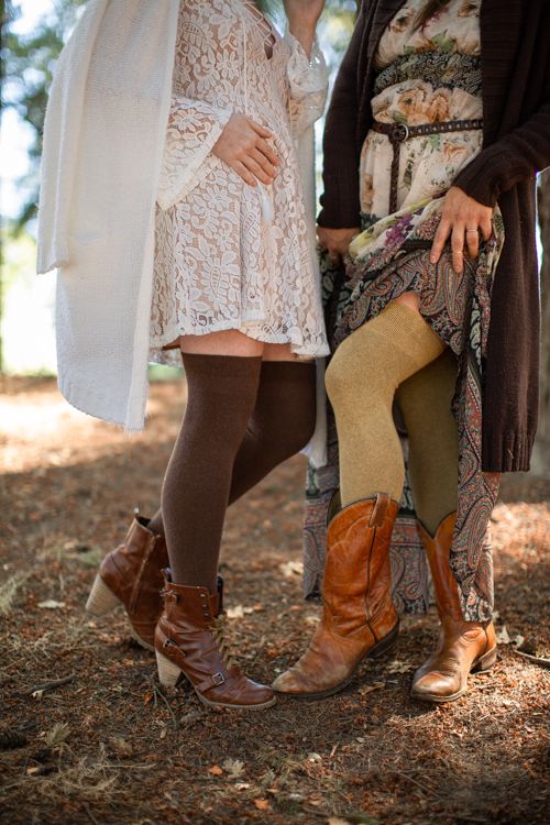 Two models wearing Extraordinary Thigh High Socks in a wooded setting